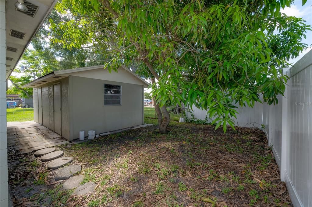 Patio leads to the rear yard and LARGE storage shed/workshop space