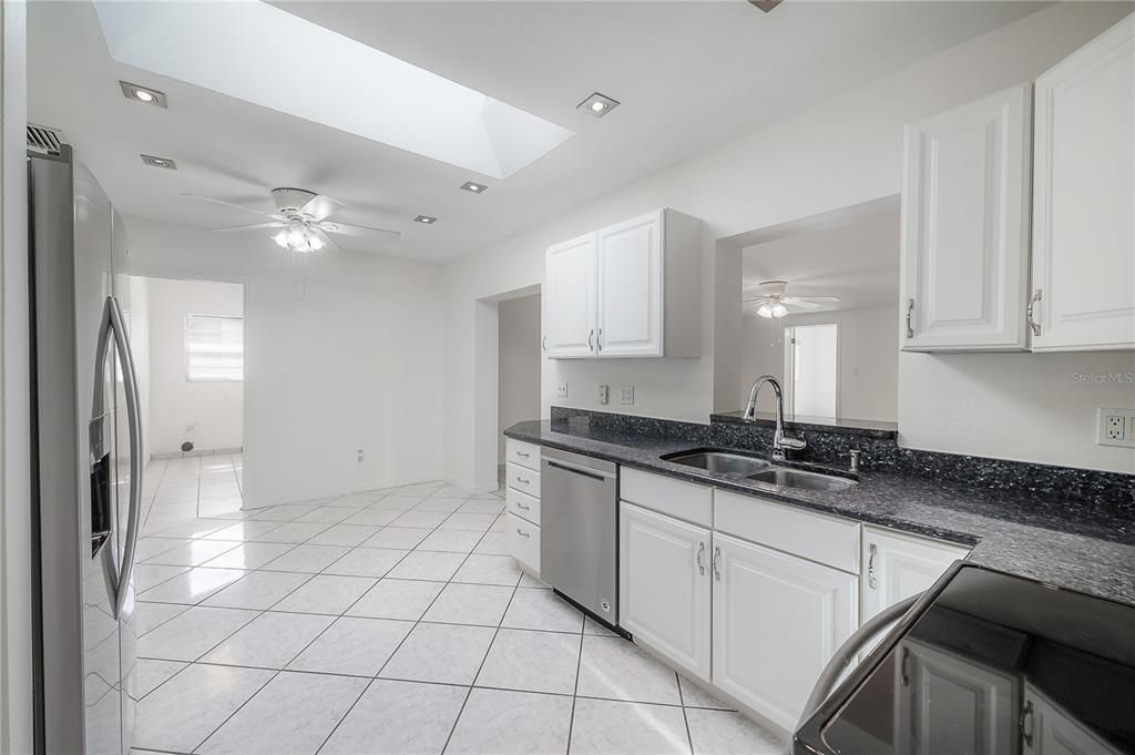 Large kitchen with stainless steel appliances, granite countertops, and pantry closet