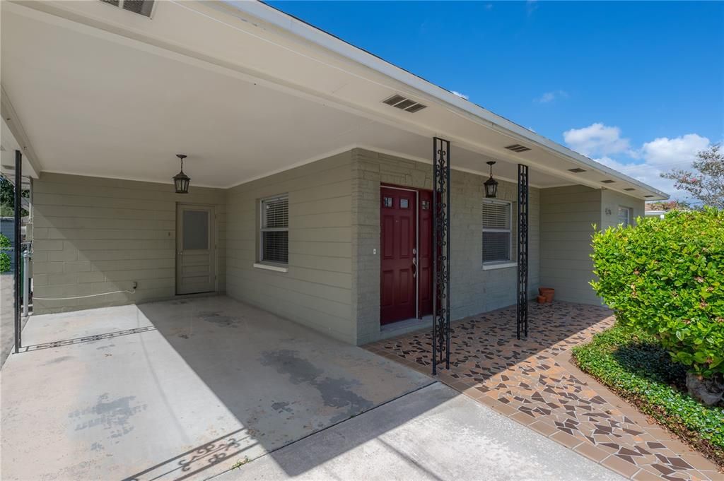 Large Carport with entry door into laundry room and kitchen