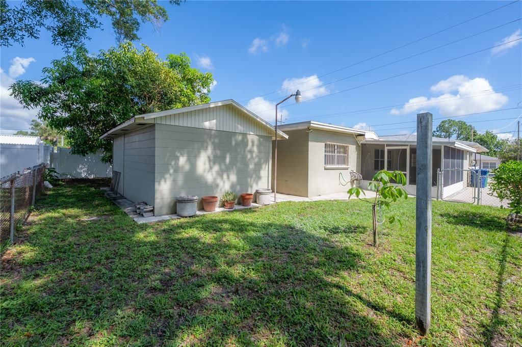 Patio leads to the rear yard and LARGE storage shed/workshop space