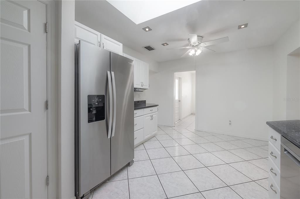 Large kitchen with stainless steel appliances, granite countertops, and pantry closet