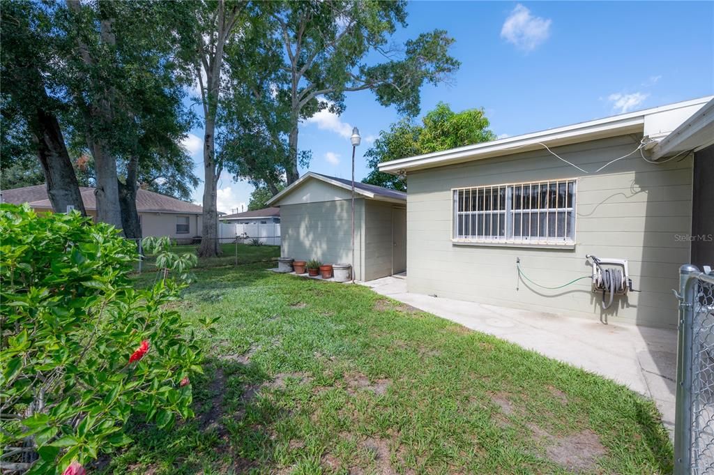 Patio leads to the rear yard and LARGE storage shed/workshop space