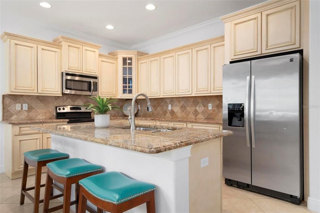 Open concept kitchen with island and stainless appliances