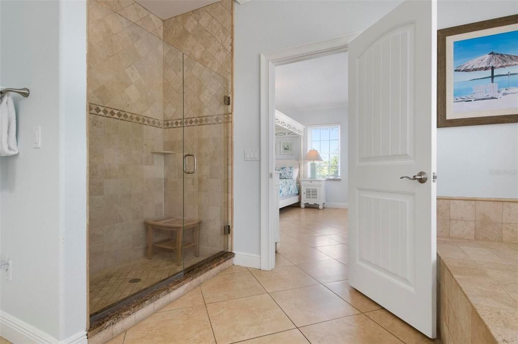 Primary #1 ensuite bath on main level with jacuzzi tub and walk in shower