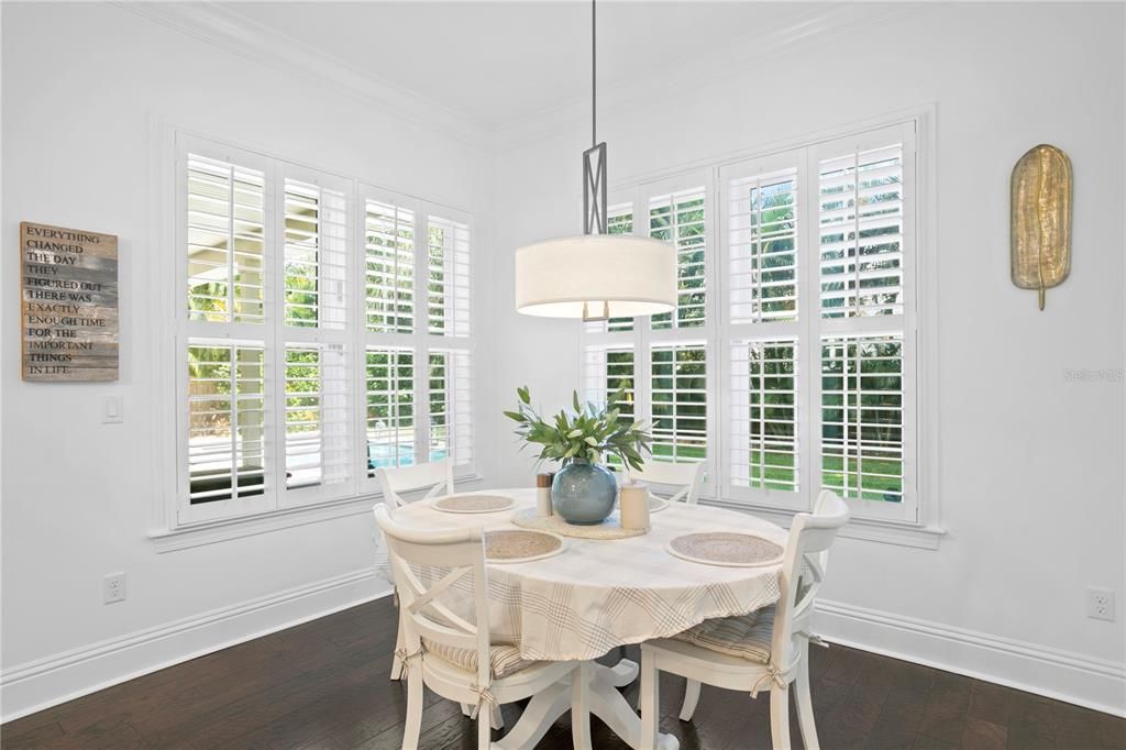 The informal kitchen table with views to the backyard and pool