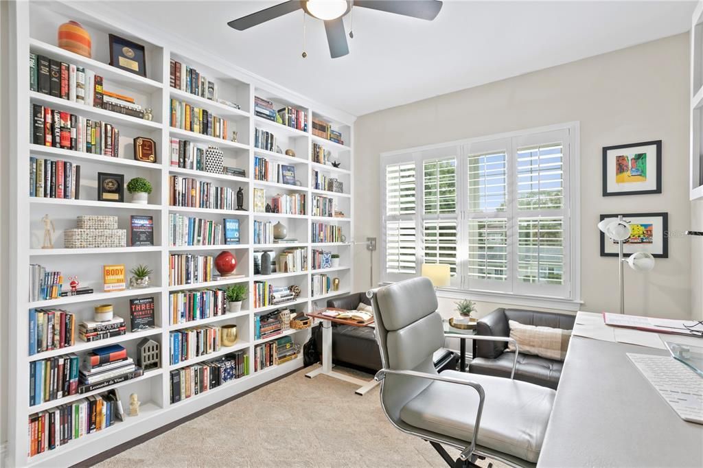 The 5th bedroom upstairs is currently used as an office space with great floor to ceiling shelving