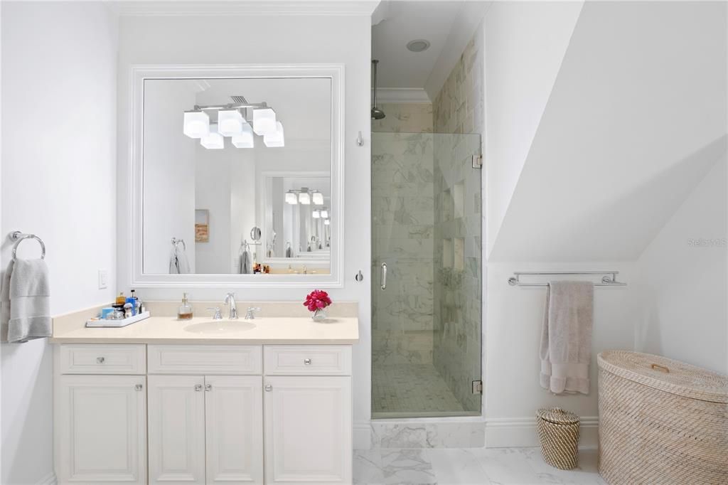 The primary bath is beautifully appointed with vaulted ceiling details adding wonderful architectural flare to the space, and is nicely appointed with split vanities, oversized walk-in shower, and a free-standing tub.