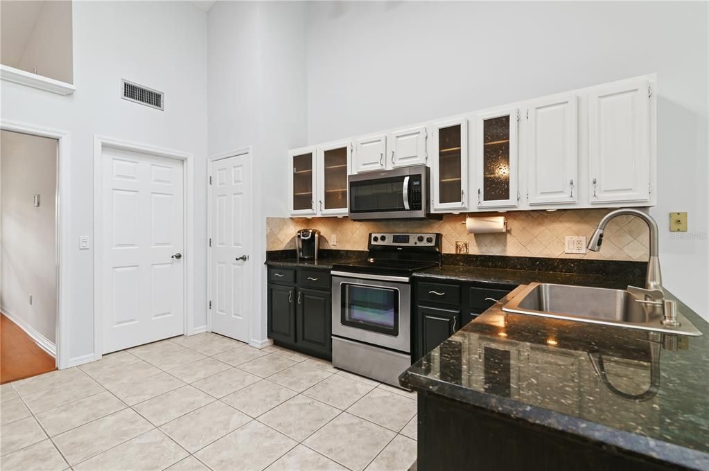 The kitchen with granite countertops and stainless steel appliances.