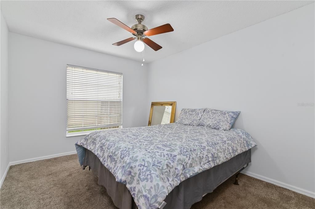 This guest bedroom is conveniently located near the guest bathroom.