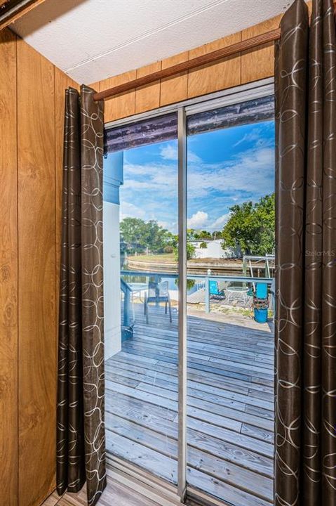 Bedroom access to back deck and waterfront through this glass sliding door.