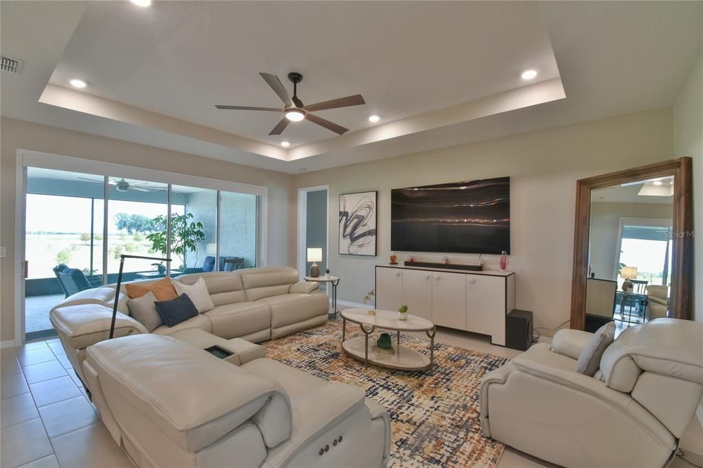 Living room with recessed ceiling and lighting
