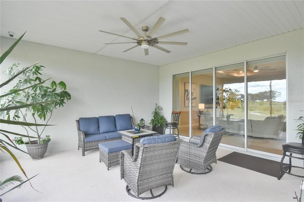 Large screened in rear porch overlooking green space.
