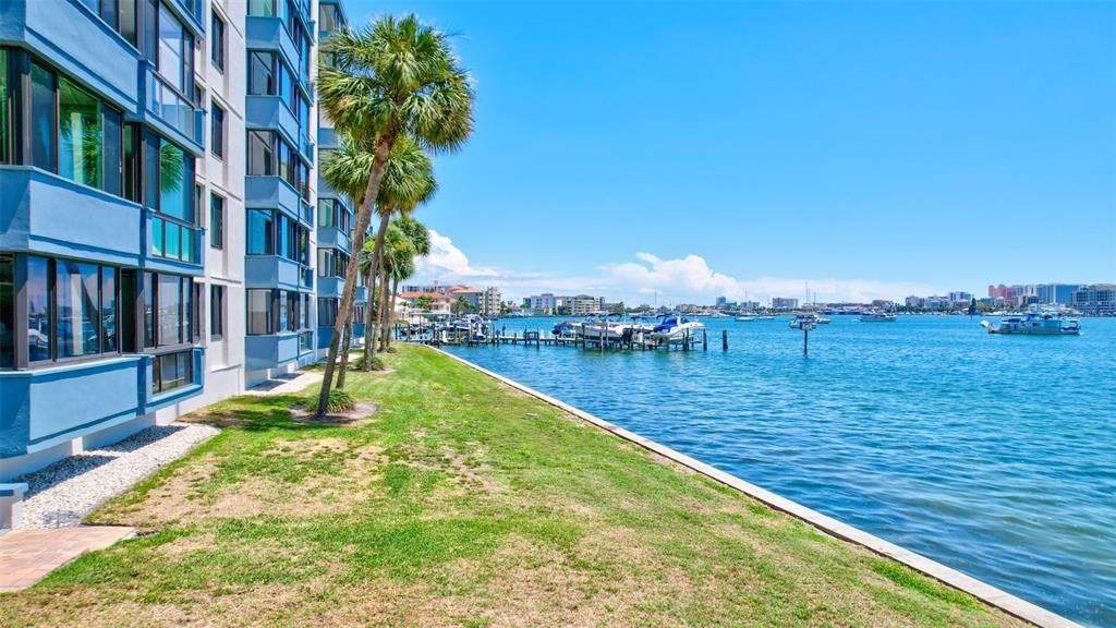 Enjoy the serene backyard of this condo unit, featuring picturesque views of the water, along with convenient access to the dock and boat slips.