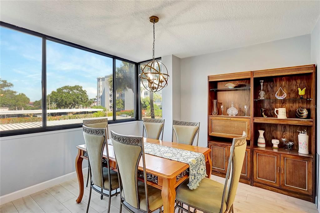 Adjacent to the large windows, the dining area in this exquisite condo offers a perfect setting for enjoying meals with a view.