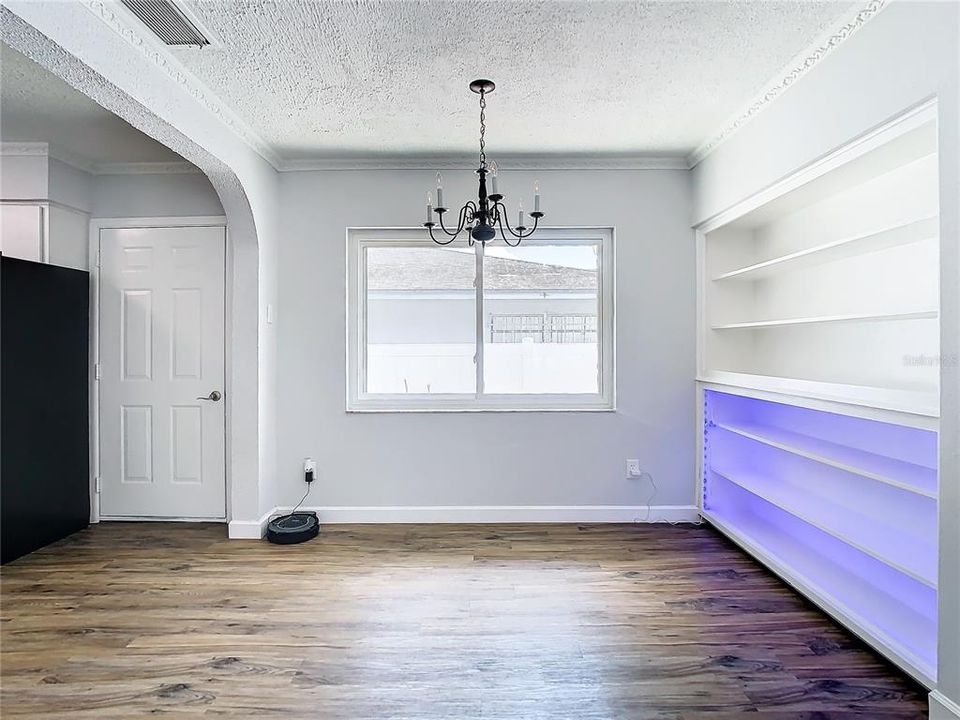 Dining room with lighted built ins.