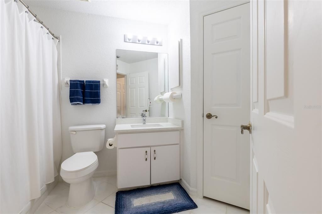 The 3-fixture second Bath has Tub, Toilet, stone Vanity and linen closet.