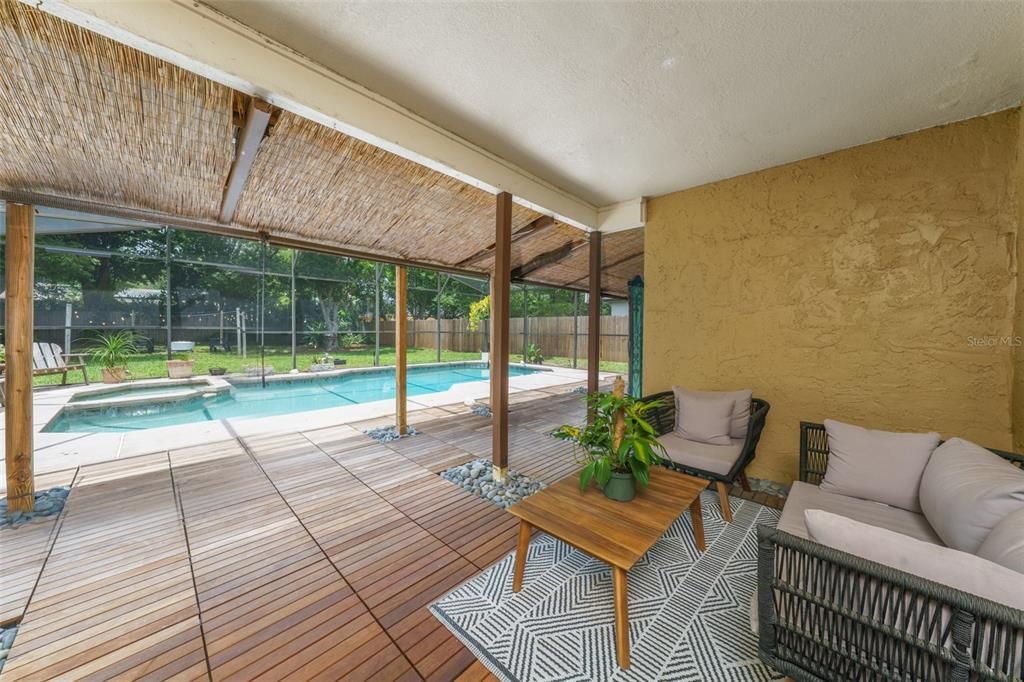 Relax on the covered patio with wood tile