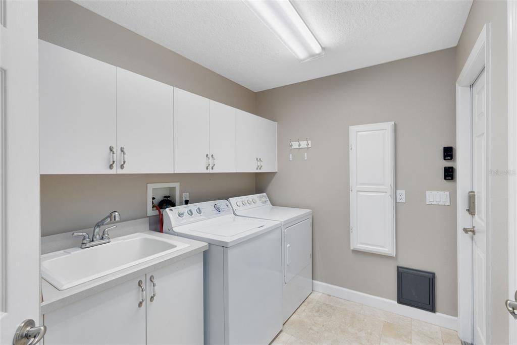 Laundry room, washer & dryer included.  Built-in ironing boaard & lots of cabinets storage