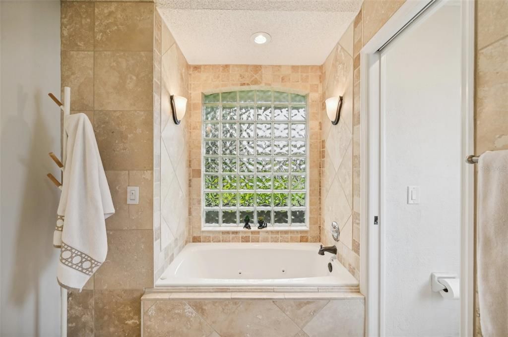 Master Bath with honed travertine, walk-in shower & enclosed toilet