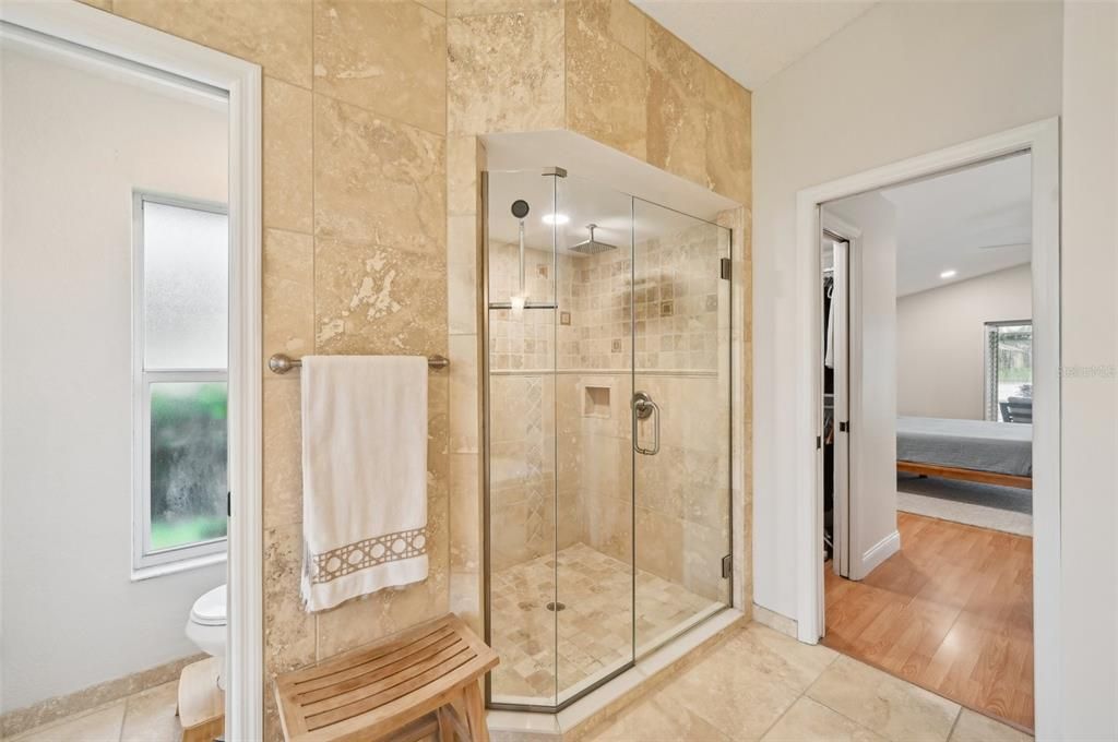 Master Bath with honed travertine, walk-in shower & enclosed toilet