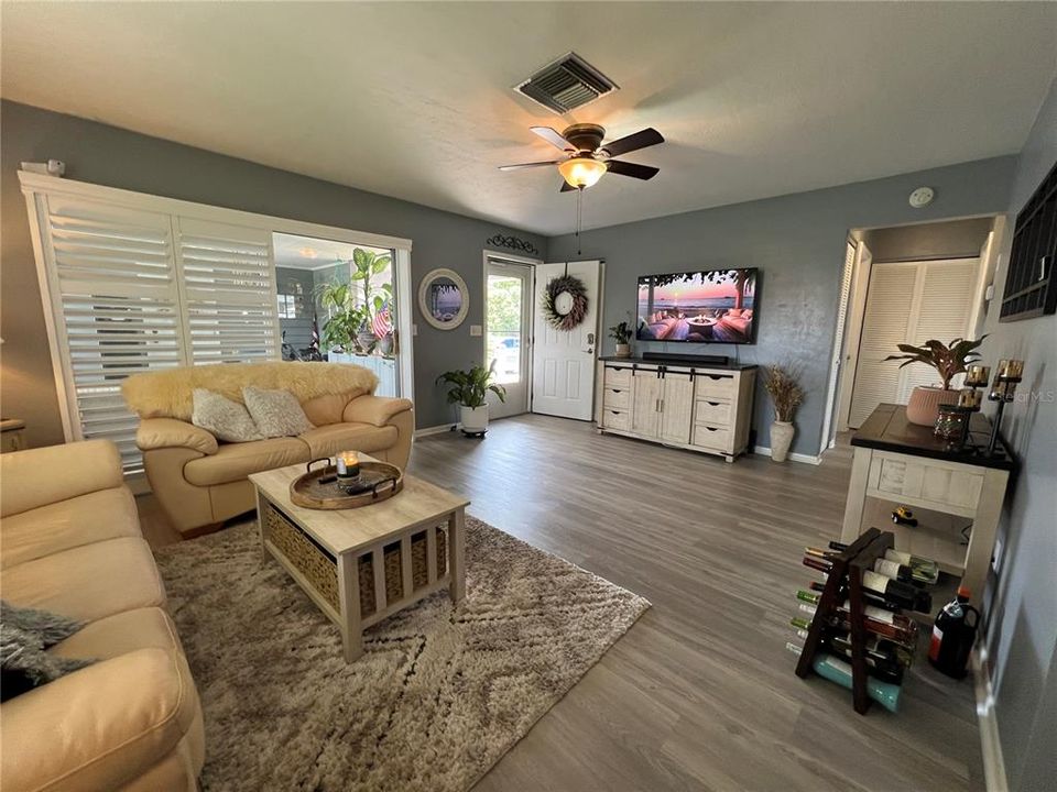 Living Room with Plantation Shutters and a Sliding Glass Door out to the Florida room (LIVING ROOM: 18X14)