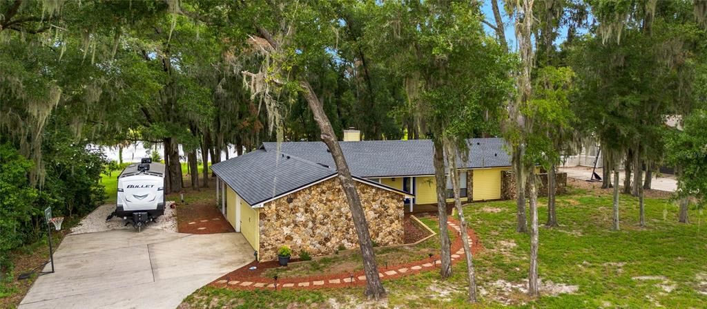 Front view with side entry garage and view of Lake Francis in the background