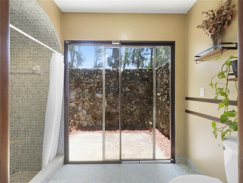 Primary Bathroom with sliding door to private patio area