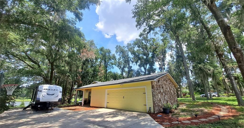 Side entry garage, RV parking pad, and 2nd porch on the side of home - this photo is with NEW ROOF