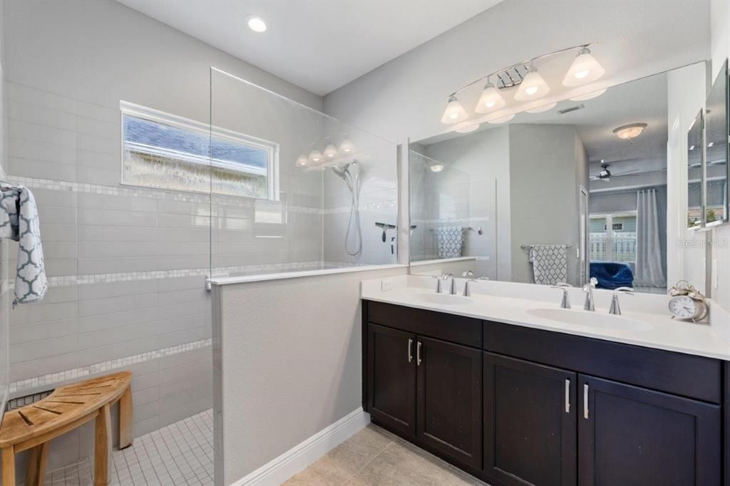 Owners ensuite bathroom featuring dual sinks, a walk-in shower, and water closet.