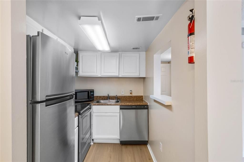 Newer stainless appliances include refrigerator, stove, dishwasher and free standing microwave