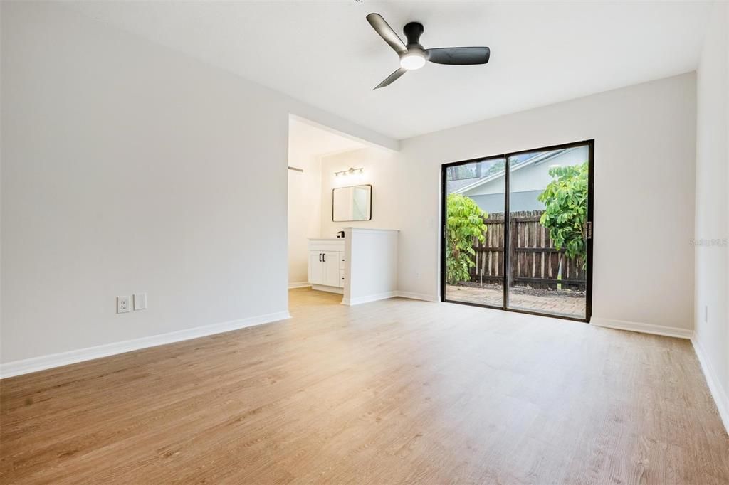 Downstairs primary bedroom with sliders going to side yard