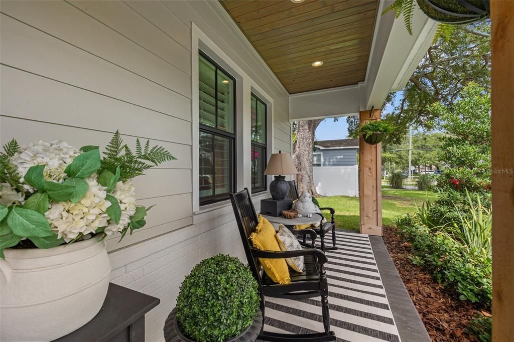 Stunning front porch with wood ceilings!