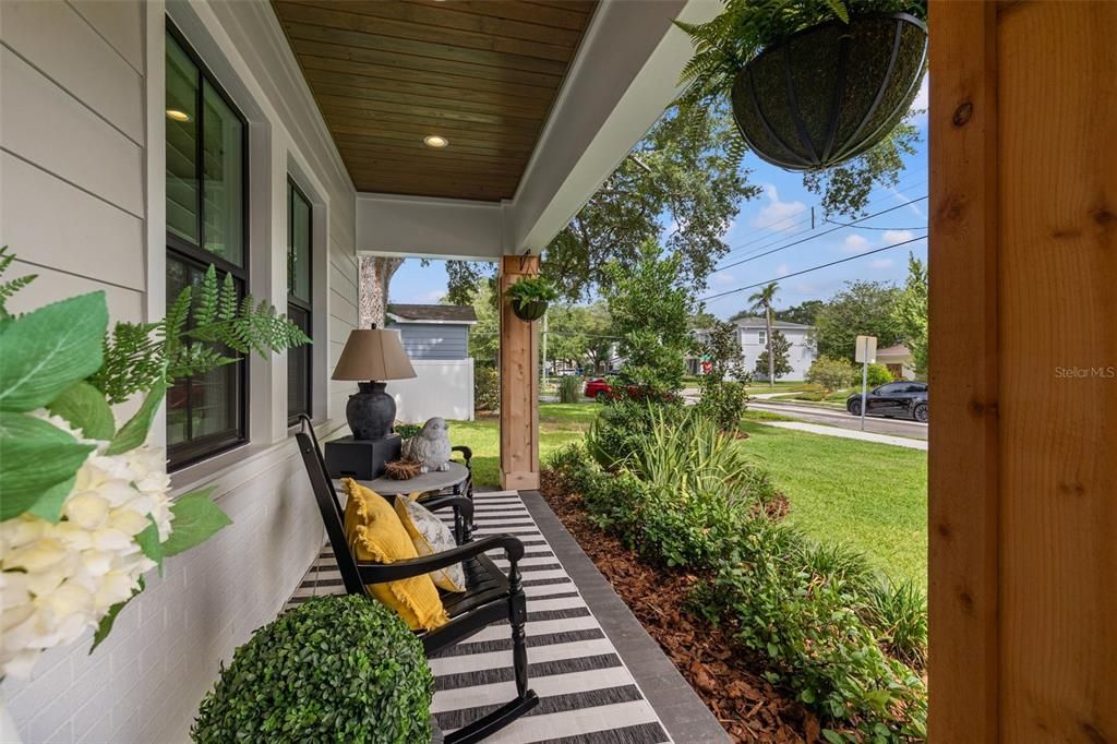 Stunning front porch with wood ceilings!