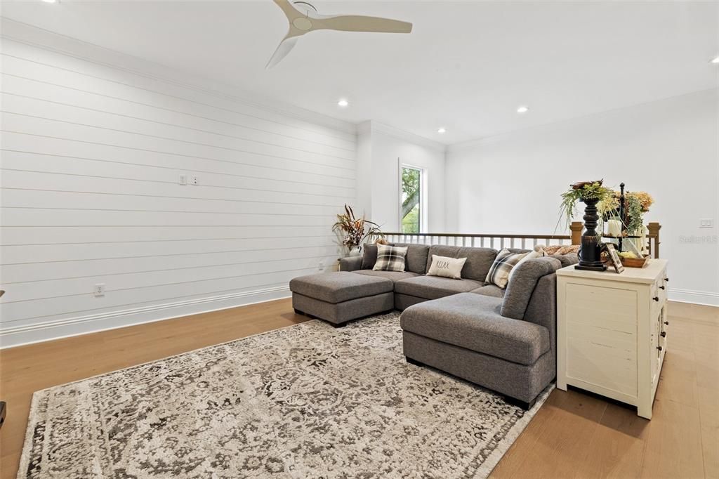 Upstairs Loft/ Bonus Room with beautiful shiplap decorative walls.