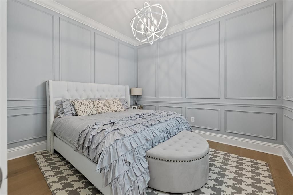 First floor office/ den/ study purposed as a guest room for this owner. Notice the beautiful decorative wainscoting!