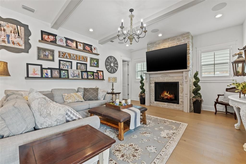 Fabulous great room with custom pinewood beams and stunning fireplace and mantle with custom stone adorning.