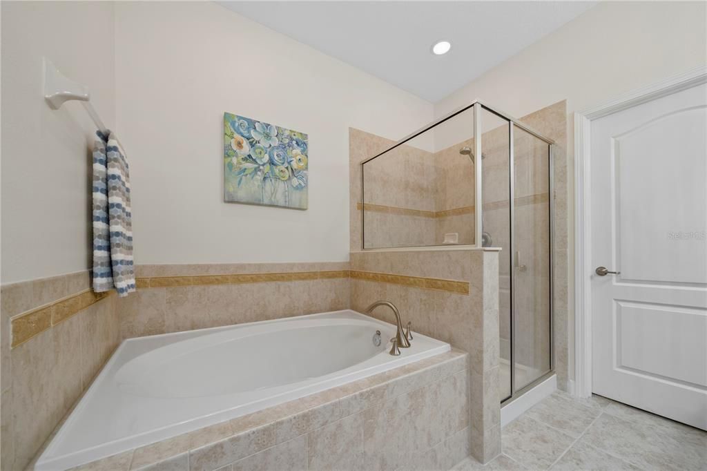 Master bath features a garden tub and a walk-in shower