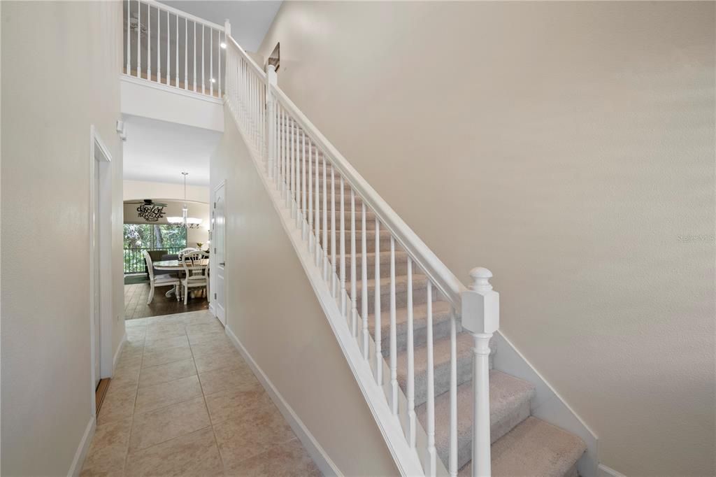 Staircase at the front of the home leads upstairs  to the bonus room, 2 secondary bedrooms and secondary bathroom