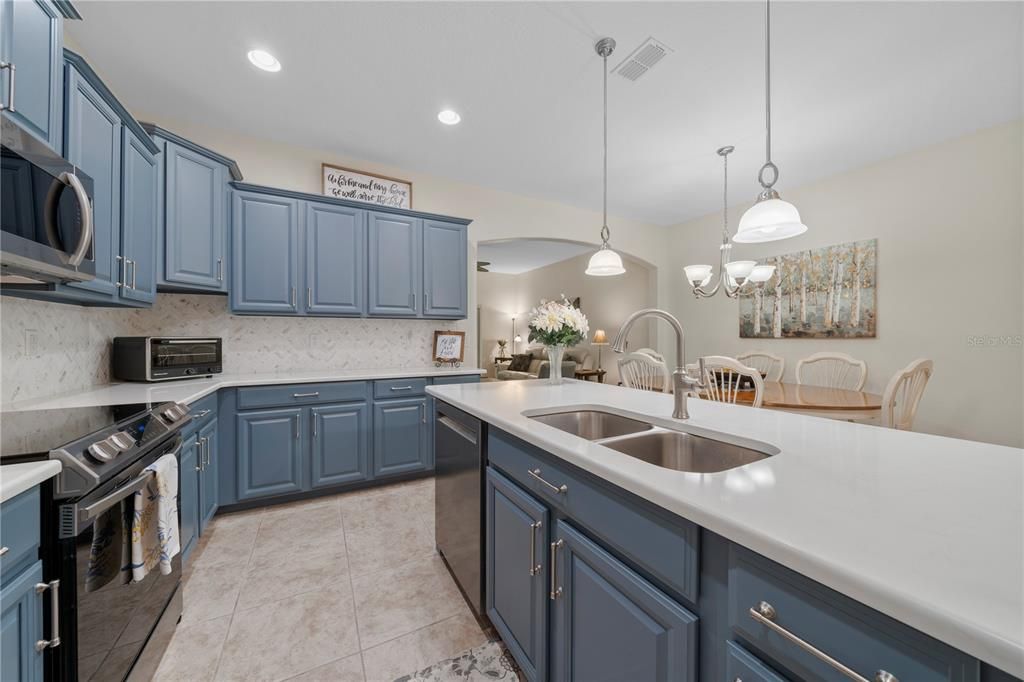 Beautifully refinished cabinets and marble backsplash in the kitchen