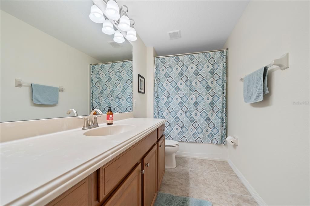 Secondary bathroom upstairs features a vanity with tons of counter space