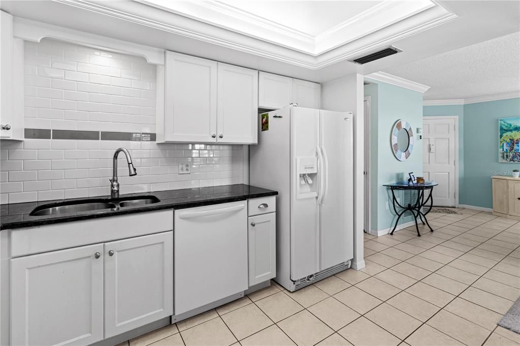 Updated Kitchen with double sink, subway tile backsplash and granite counters