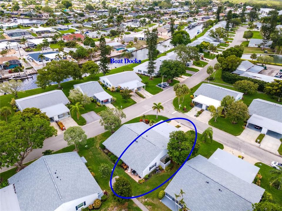 Aerial view towards south.  Boat docks and guest parking to front left of Villa.