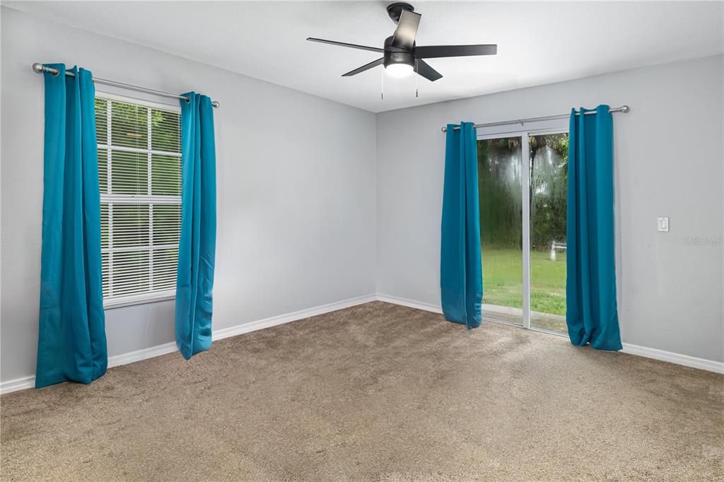 Primary Bedroom features sliding doors to the back yard.