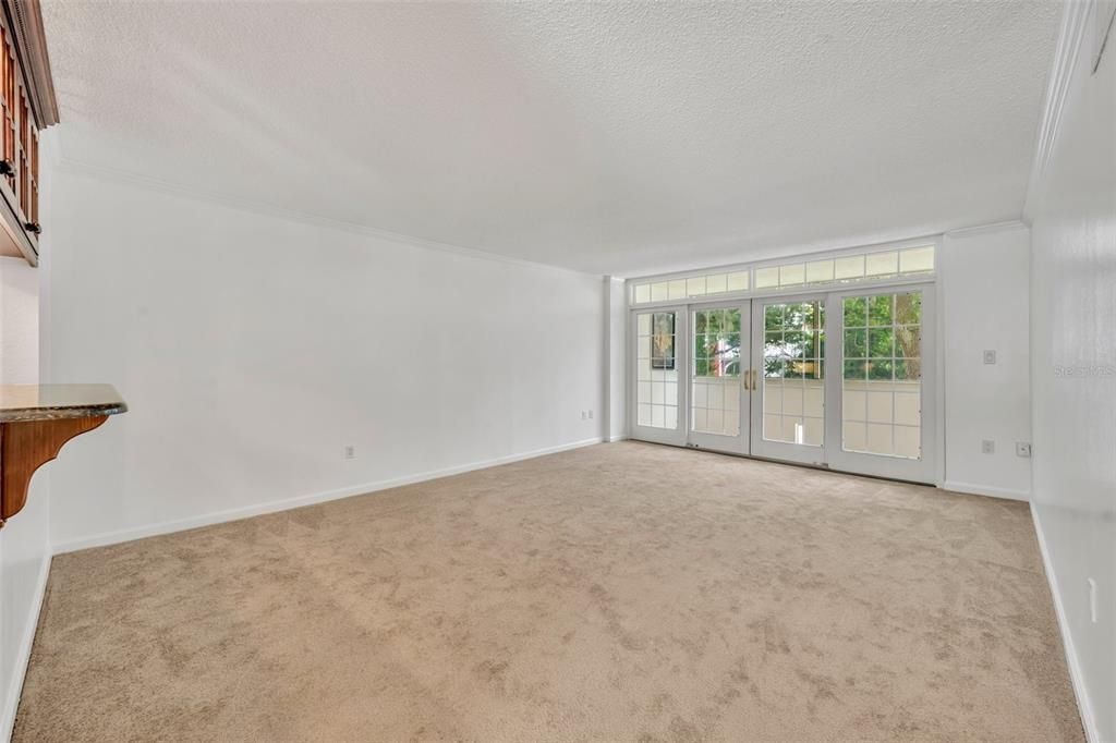 Living Room opens from kitchen. Glass cabinets