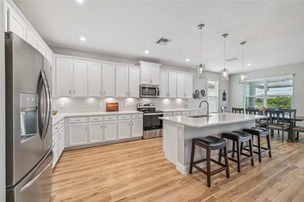 BEAUTIFUL OPEN KITCHEN WITH LARGE ISLAND COUNTER. PLENTY OF CABINET SPACE!