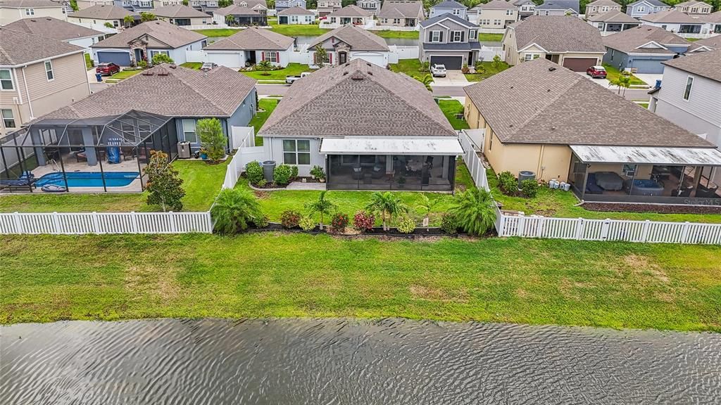 BACK OF HOUSE WITH BEAUTIFULLY MAINTAINED YARD WITH A SERENE POND VIEW