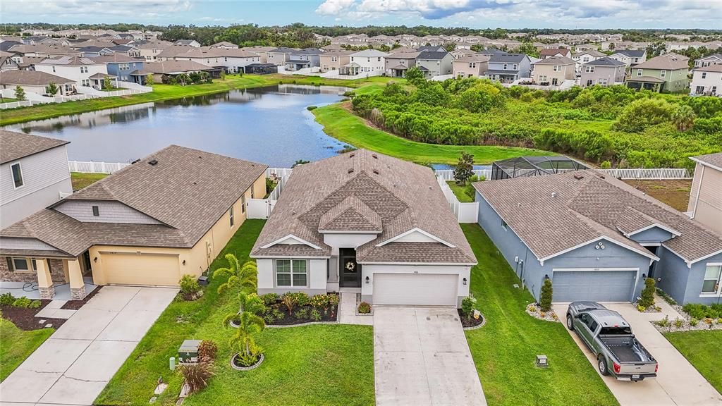 BACK OF HOUSE WITH BEAUTIFULLY MAINTAINED YARD WITH A SERENE POND VIEW