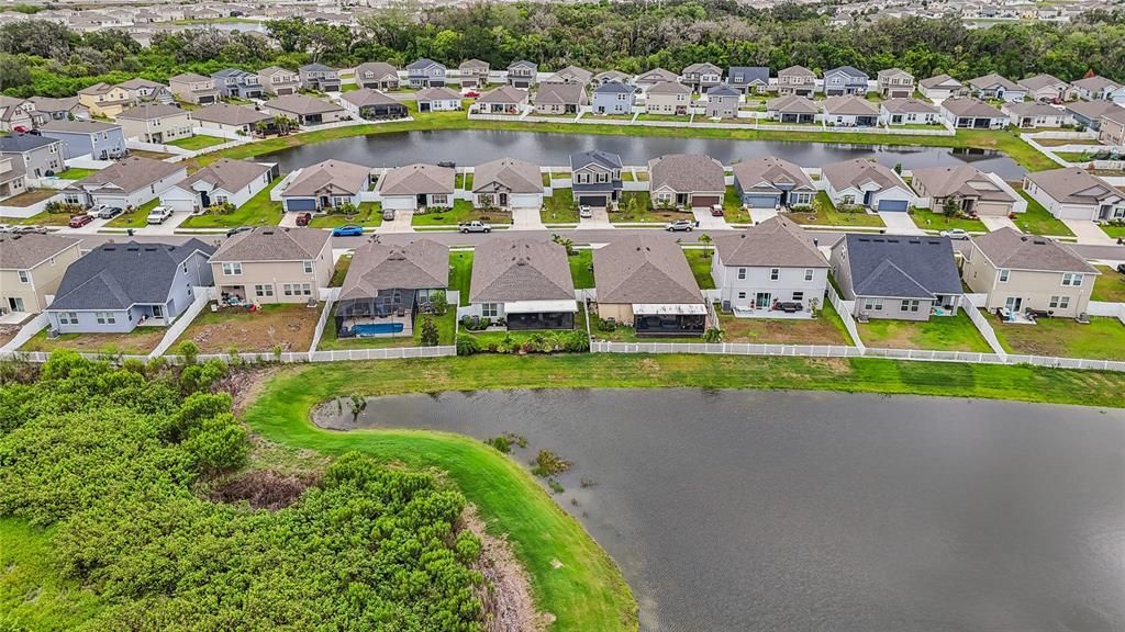 BACK OF HOUSE WITH BEAUTIFULLY MAINTAINED YARD WITH A SERENE POND VIEW