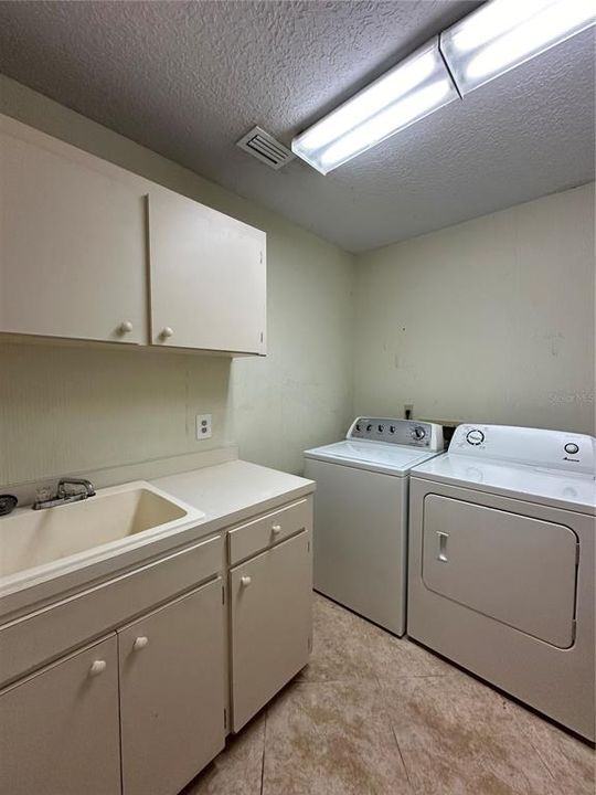 Laundry Room with Washer, Dryer and Cabinetry