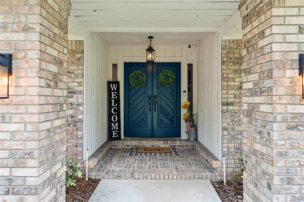 Welcoming front entry with couch lights and double doors